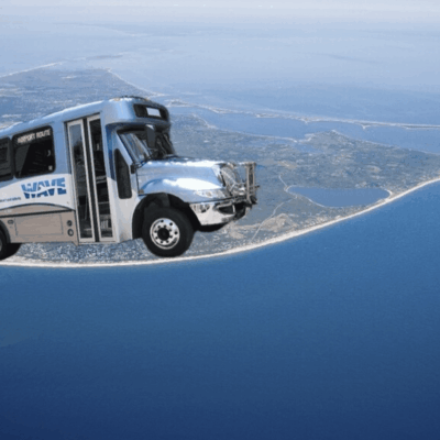 An aerial view of a RIPTA bus flying over an island.