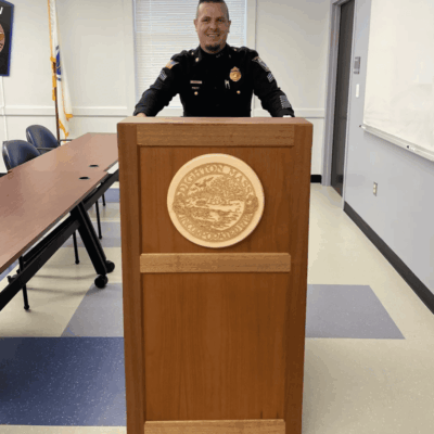 A Bristol Plymouth Regional Tech police officer standing in front of a podium.