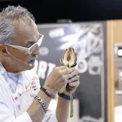 Chef Walter Potenza is holding a flower in his hand.