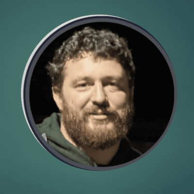 An image of a man with a beard in a circle at the Big New England Football Clinic.