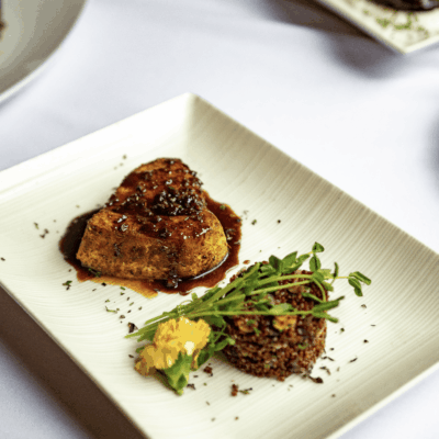 A plate of food with recipes on a table.