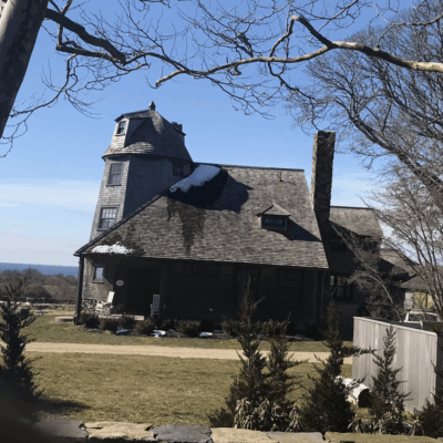 A house in Little Compton with a clock on top of it.