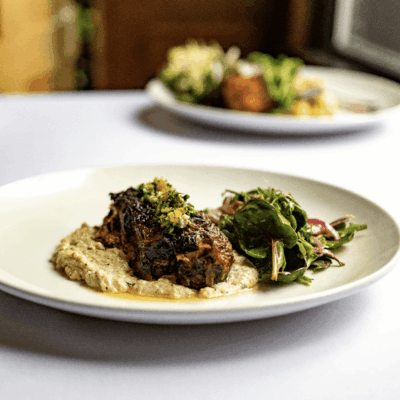 Braised short rib with puree and salad.