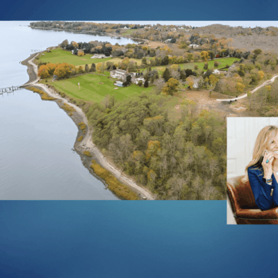 Here's an 8-word alt tag for the image: Waterfront estate, woman on phone, luxurious property.