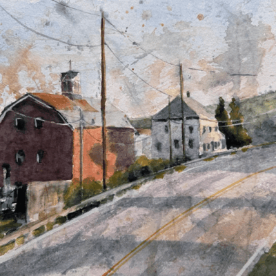 Rural road scene with barn and houses.