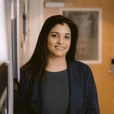 Smiling woman in a dark blazer.