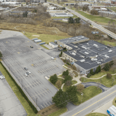 Aerial view of a large building and parking lot.