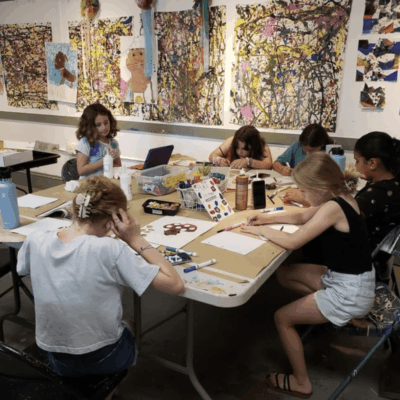 Kids creating art in a classroom.
