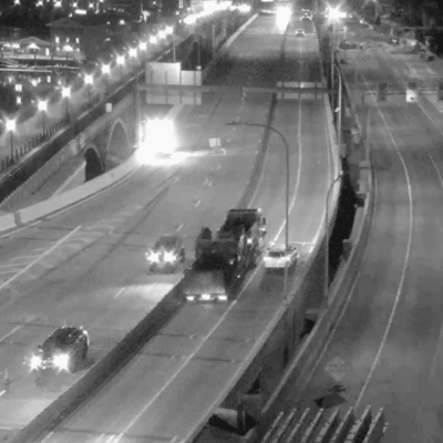 Nighttime highway traffic, several vehicles.