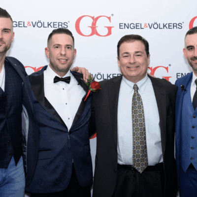 Four men in suits at Engel & Vlkers event.