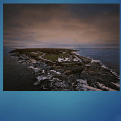 Lighthouse on rocky island coast.