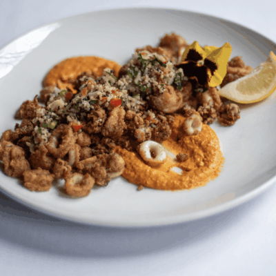 Fried calamari with quinoa and sauce.