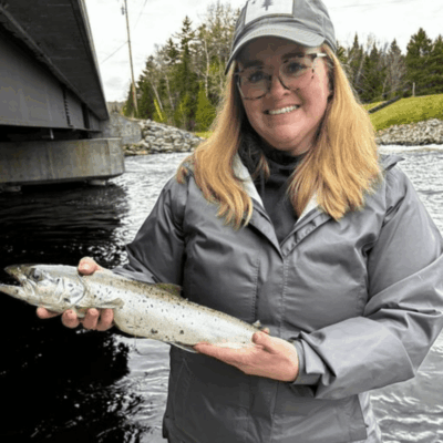 Woman holding a freshly caught salmon.