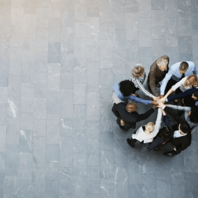 Teamwork: Diverse colleagues joining hands.