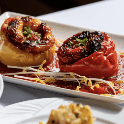Stuffed peppers with sauce and sprouts.