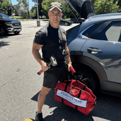Man with sledgehammer and Engel & Vlkers bag.