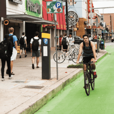 Man cycling on green bike lane.