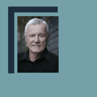 Here's a short alt tag for the image: `Portrait of smiling older man`