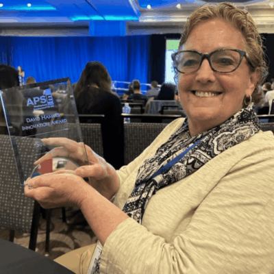 Woman holding David Hammes Innovation Award.