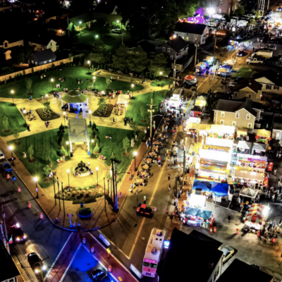 Nighttime town festival in park.