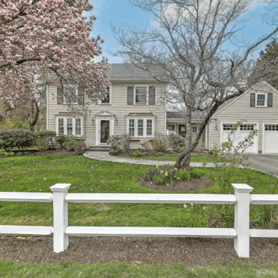 Suburban home with blooming magnolia tree.