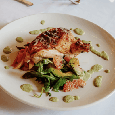 Grilled chicken with roasted vegetables and herbs.