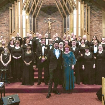 Large choir group posing for photo.