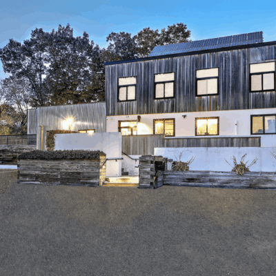 Modern house with solar panels at dusk.
