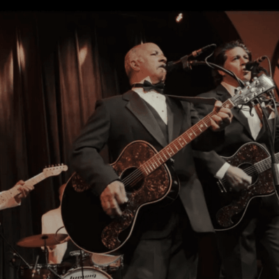 Band playing guitars on stage.