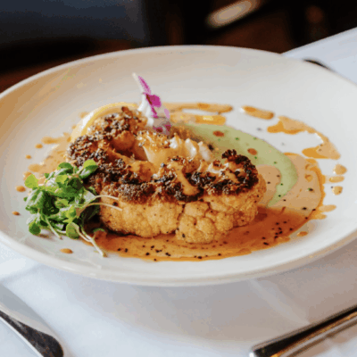 Roasted cauliflower steak with sauce.