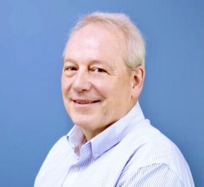 Headshot of a smiling older man.
