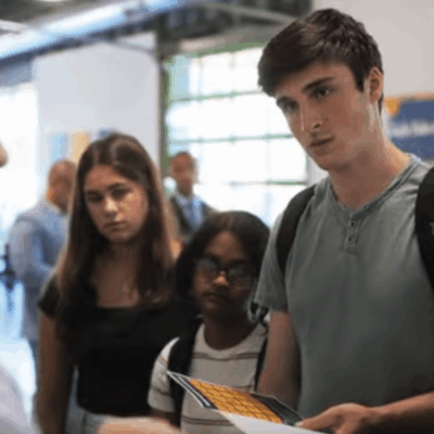 Students show teacher a project.