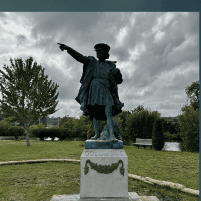 Columbus statue in park setting.