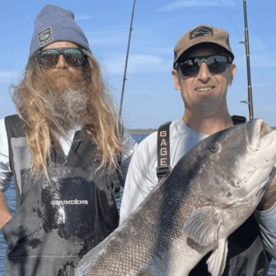 Two fishermen with a large fish.