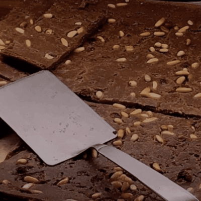 Chocolate cake slices with pine nuts.