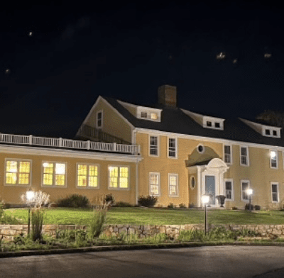 A large yellow building with lights on the outside.