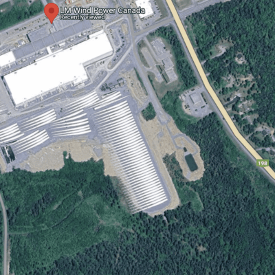 A satellite image of an industrial area with trees.