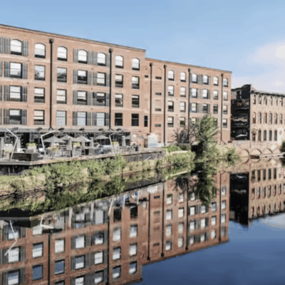 A building with many windows and a river