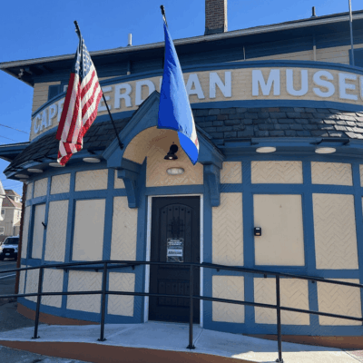 A building with two flags on the front of it.