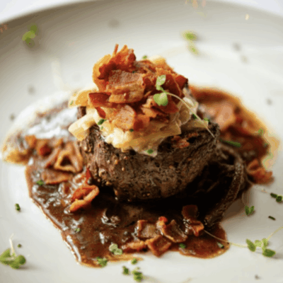 A plate of food with meat and sauce on it.