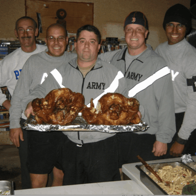 A group of men holding trays with food on them.