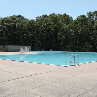 A swimming pool with trees in the background