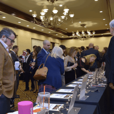 A group of people standing around a table.
