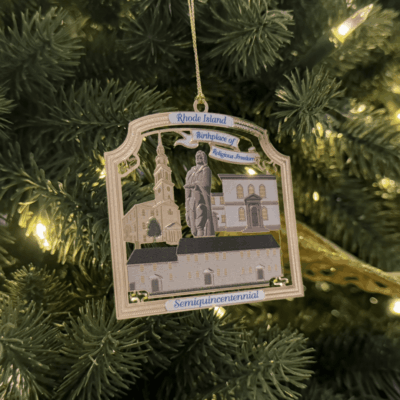 A christmas ornament hanging from the side of a tree.