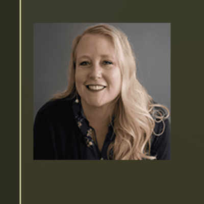 A woman with long blonde hair smiling for the camera.