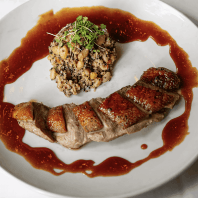 A plate of food with meat and sauce on it.