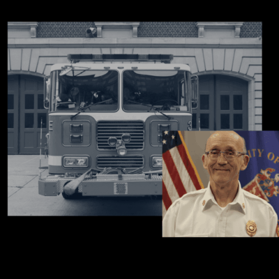 A picture of an old fire truck and a man in front of it.