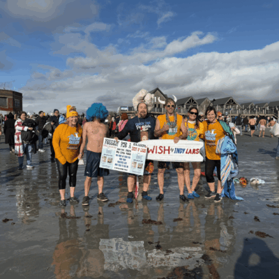 A group of people standing on top of a beach.