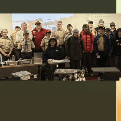 A group of people standing in front of a table.