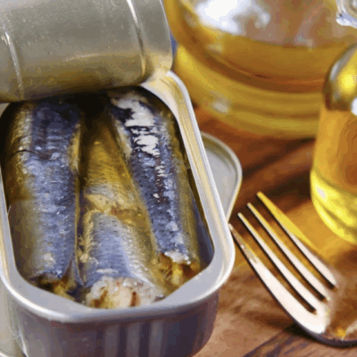 Open can of sardines with olive oil.